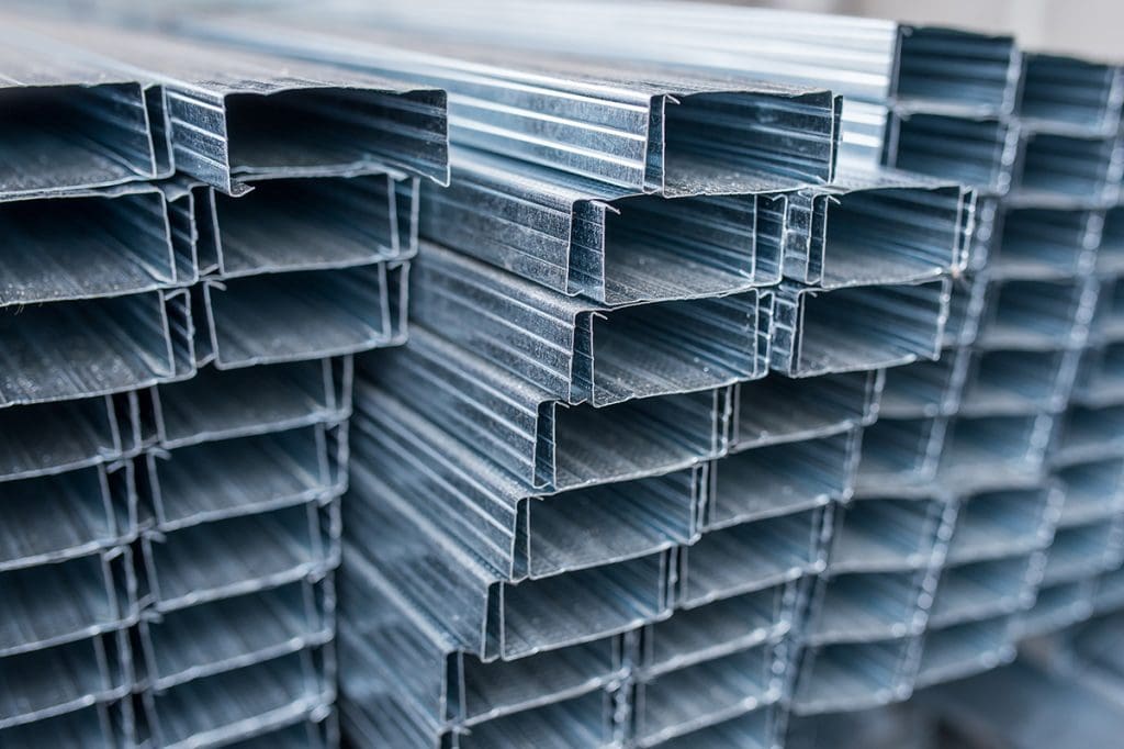A stack of aluminum frame pieces in profile in preparation for fabrication