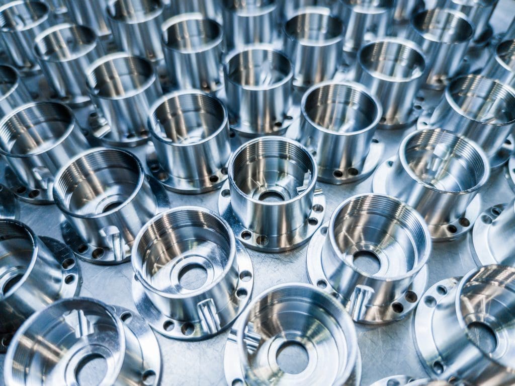Some aluminum valves on display on a table and shined
