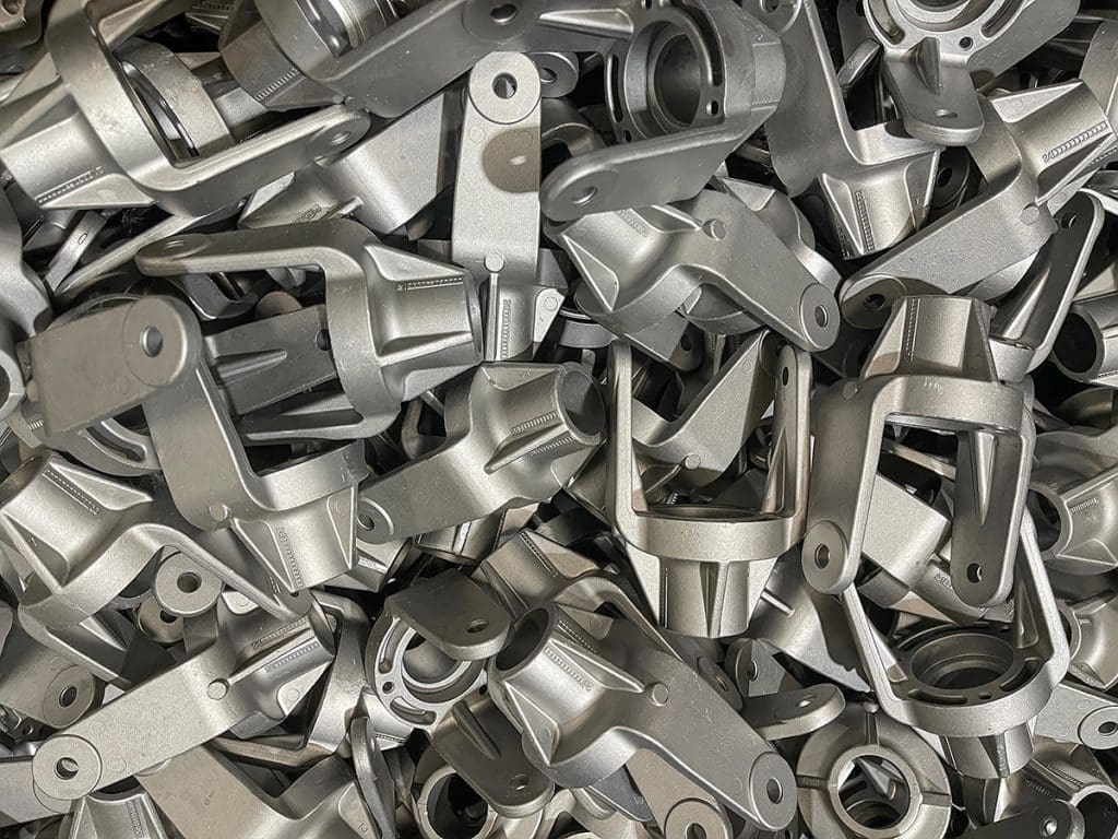 A large number of aluminum fasteners stacked on top of each other